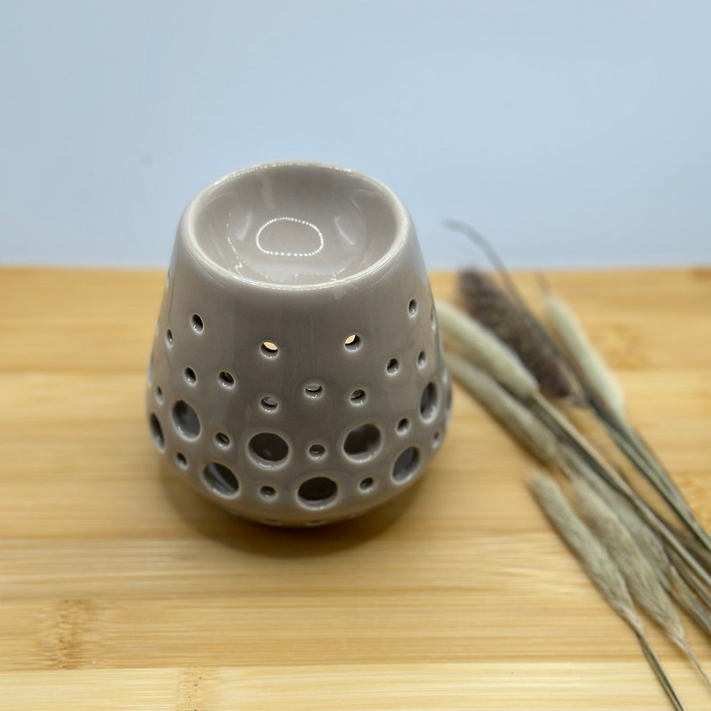 Bovenaanzicht van grijze keramieken waxbrander met ronde smeltopening.